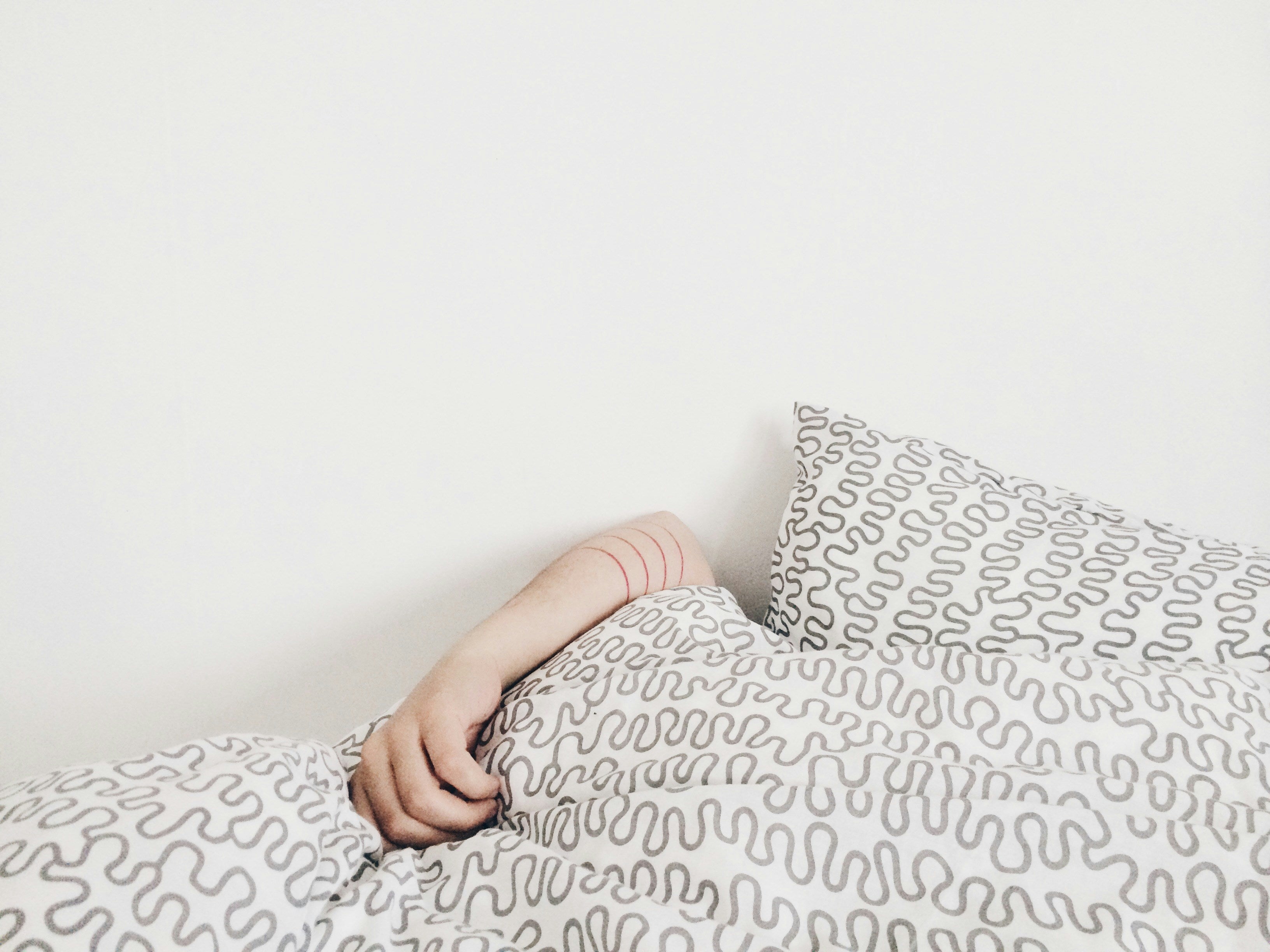 bed sheet with person sleeping