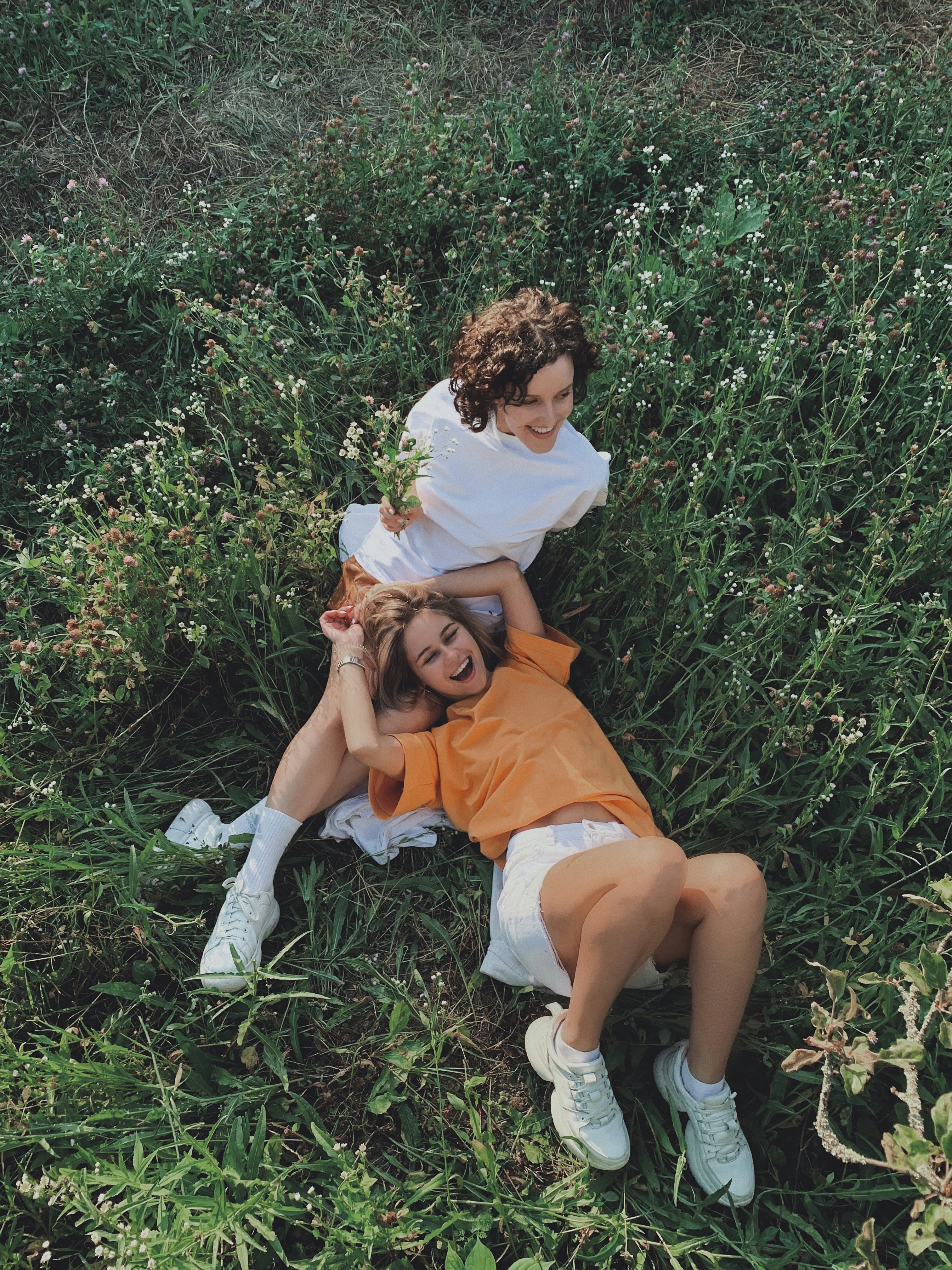 Girls laying happily on grass