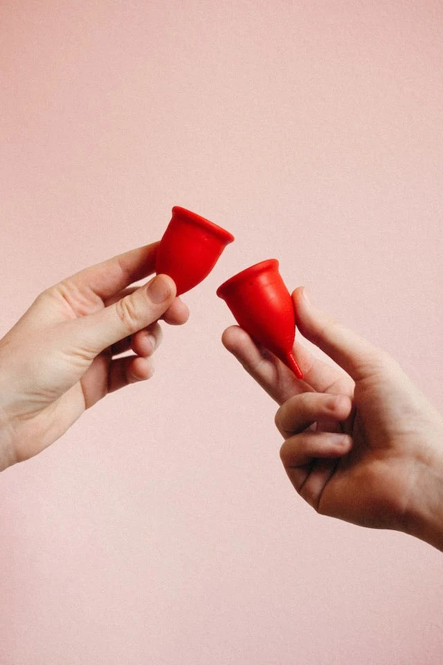 menstrual cups on pink background