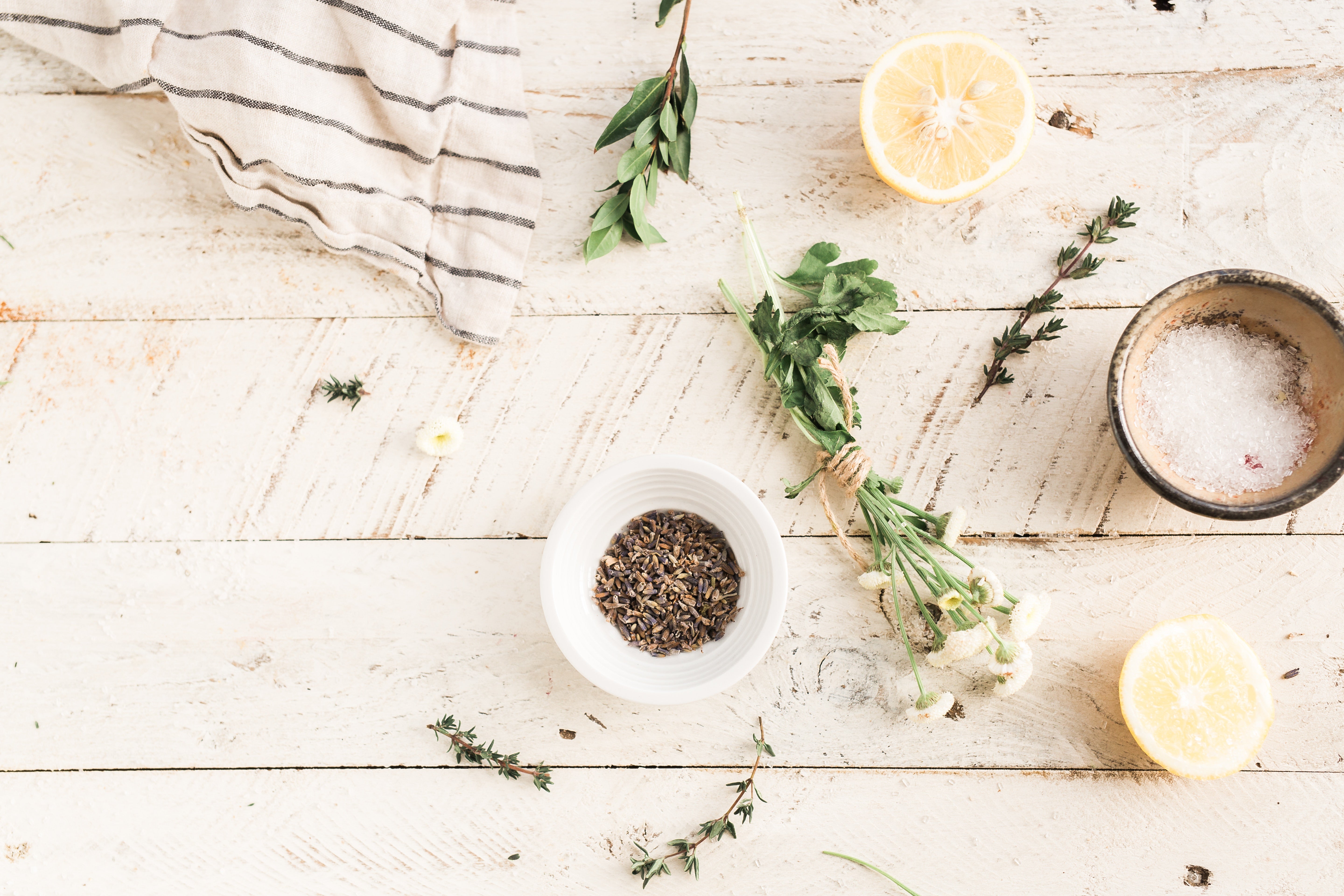 herbs and tea on a white wooden table