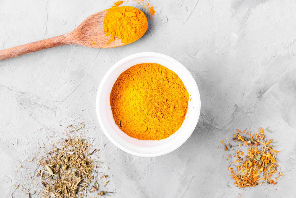 turmeric powder in bowel with spoon