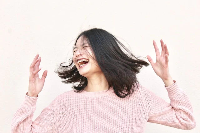 girl looking happy shaking her head