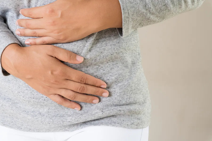woman holding stomach thats bloated