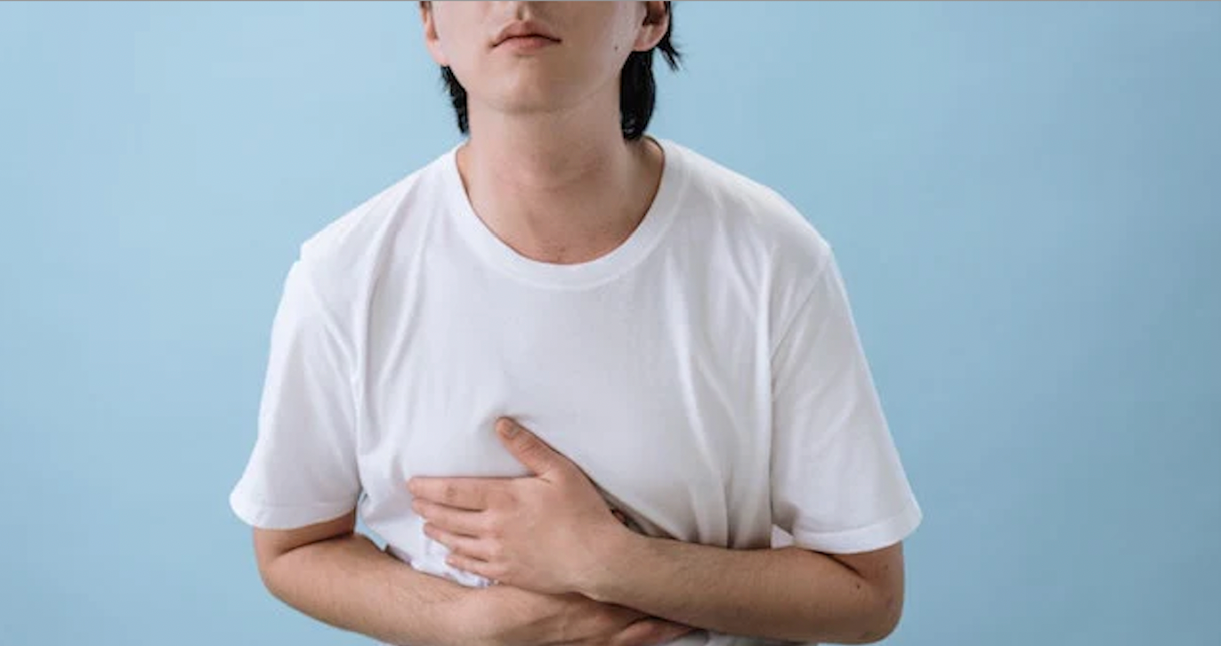 man holding stomach while bloated