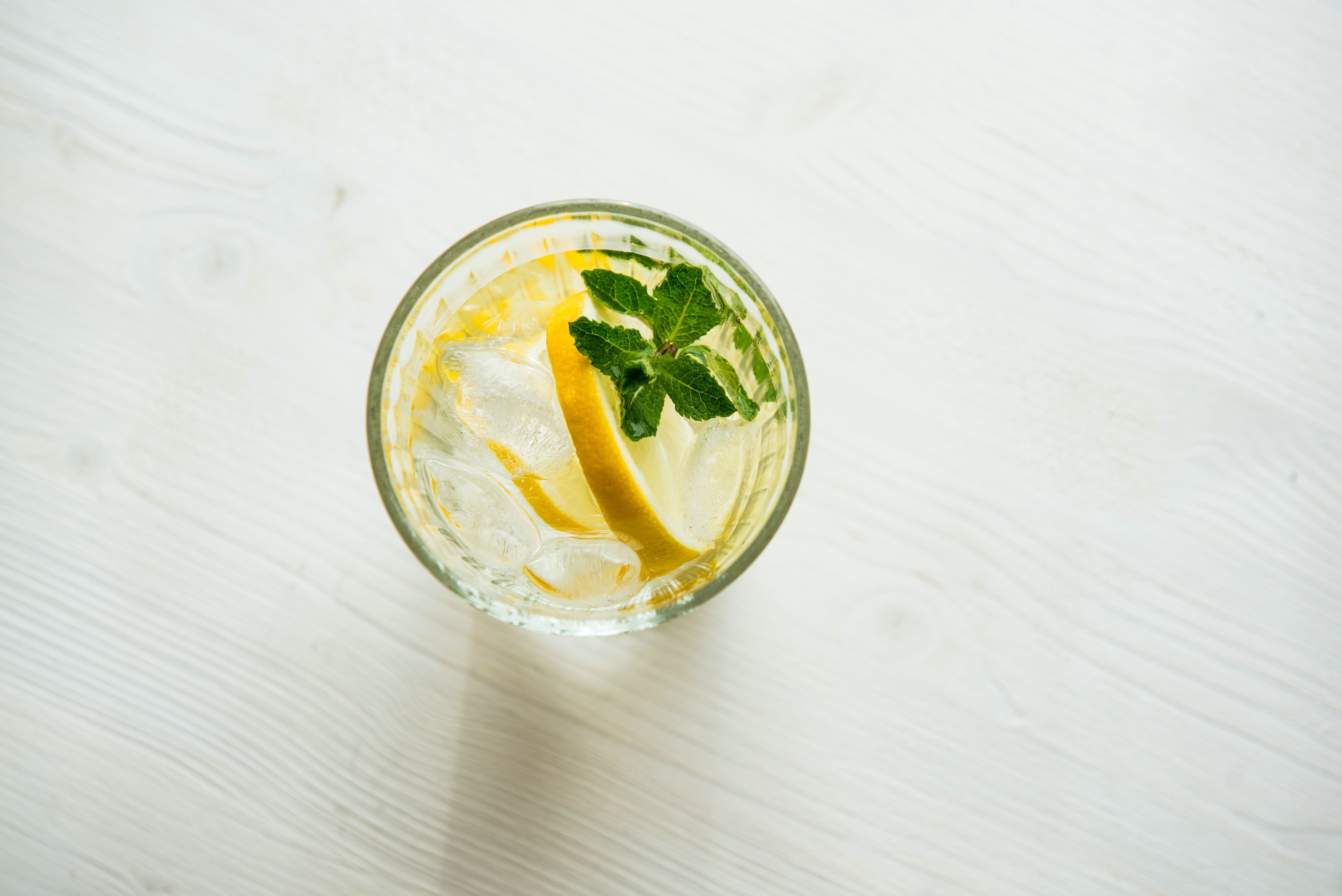glass of water with lemon slice in it