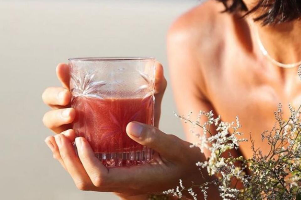 woman holding gut healthy drink in hand